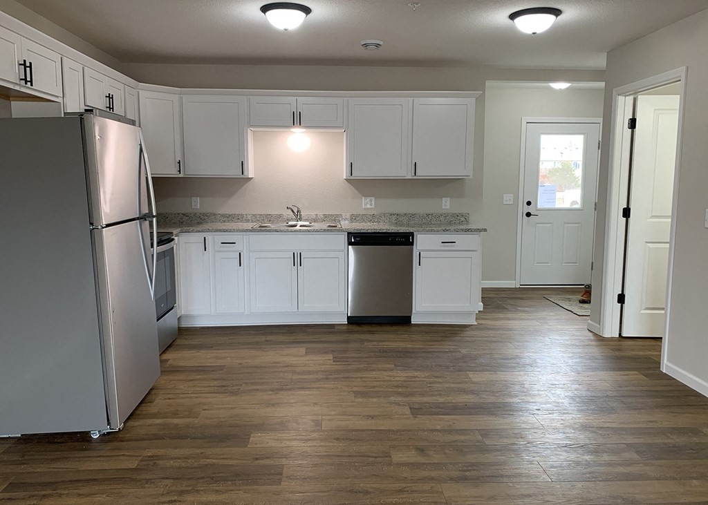 a kitchen with white cabinets and stainless steel appliances