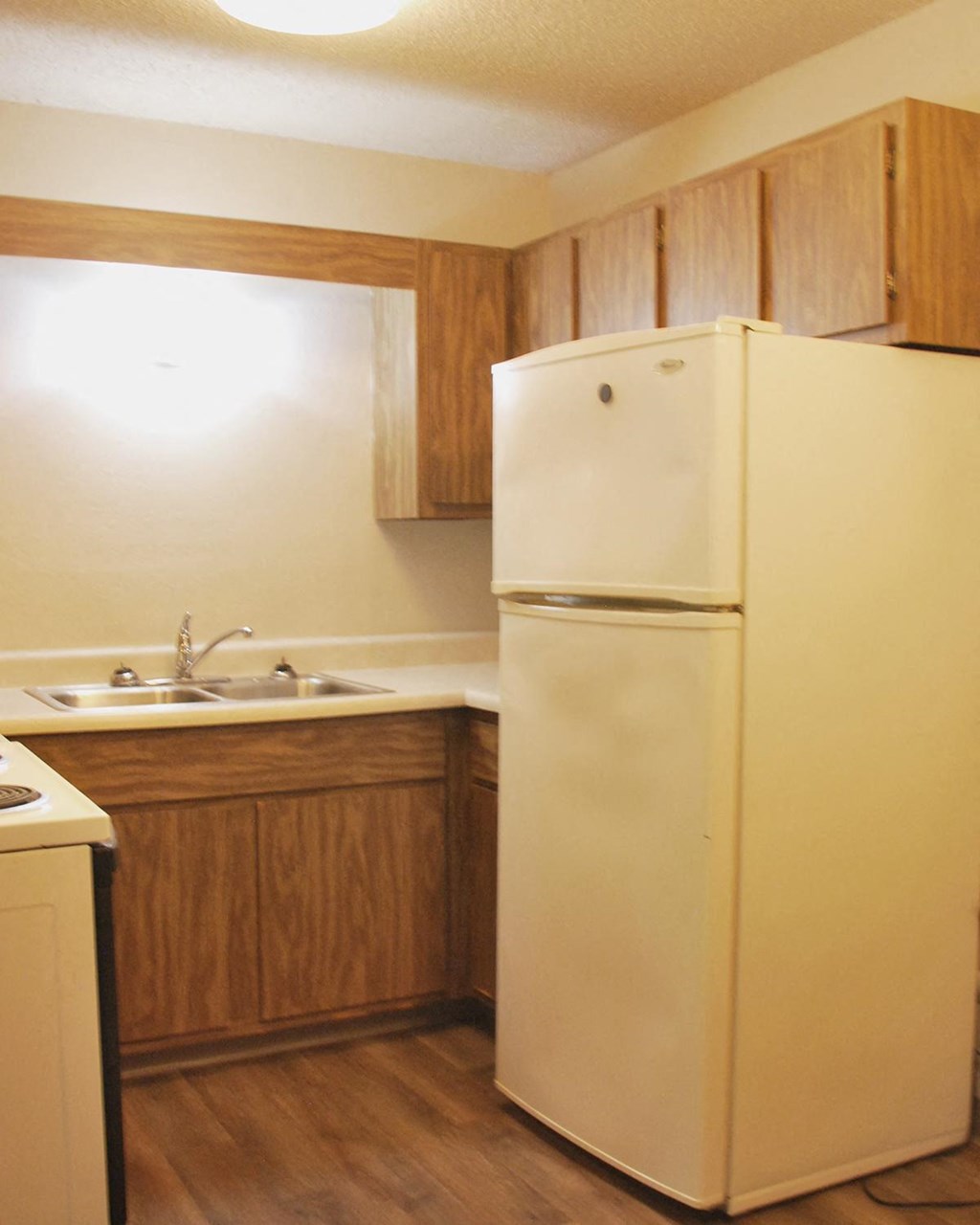 a kitchen with a refrigerator and a sink