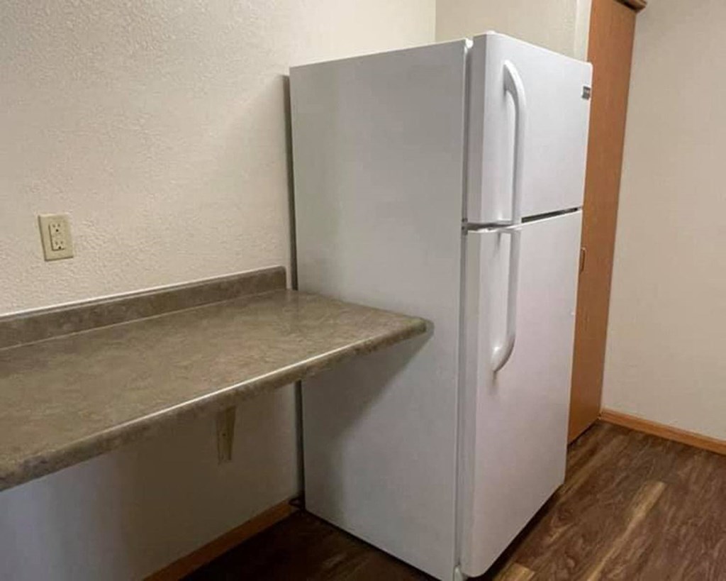 a white refrigerator in a room with a counter
