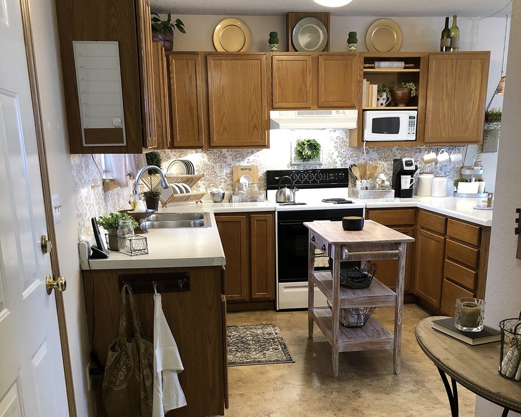 a kitchen with wooden cabinets and a white counter top