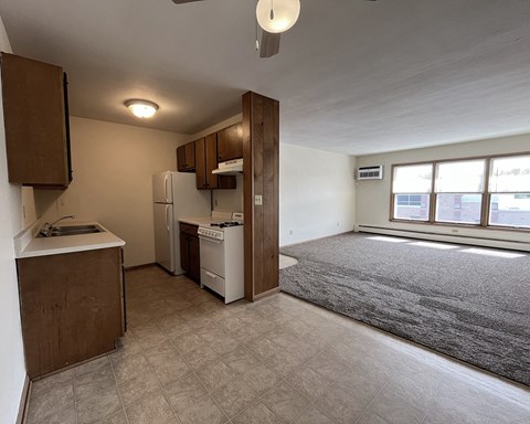 an empty kitchen and living room in an empty apartment