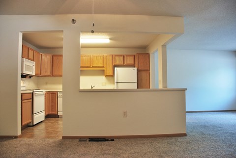 A kitchen with wooden cabinets and a white refrigerator.