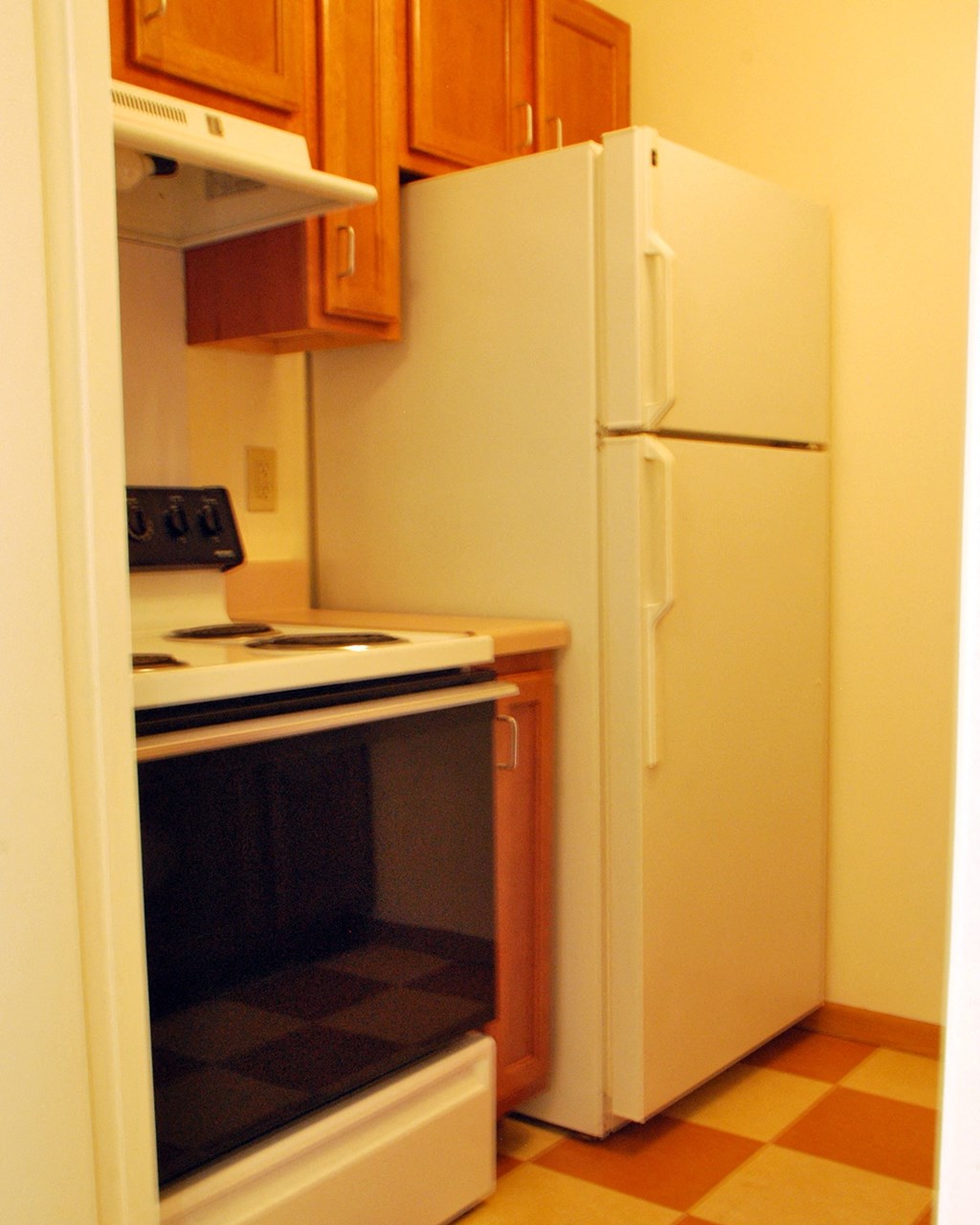 a kitchen with a refrigerator and a stove