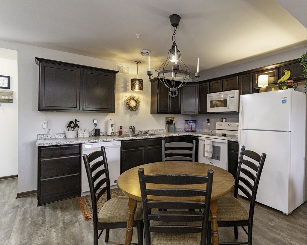 a kitchen with a dining table and a refrigerator