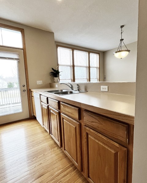 A kitchen with wooden cabinets and a white countertop.