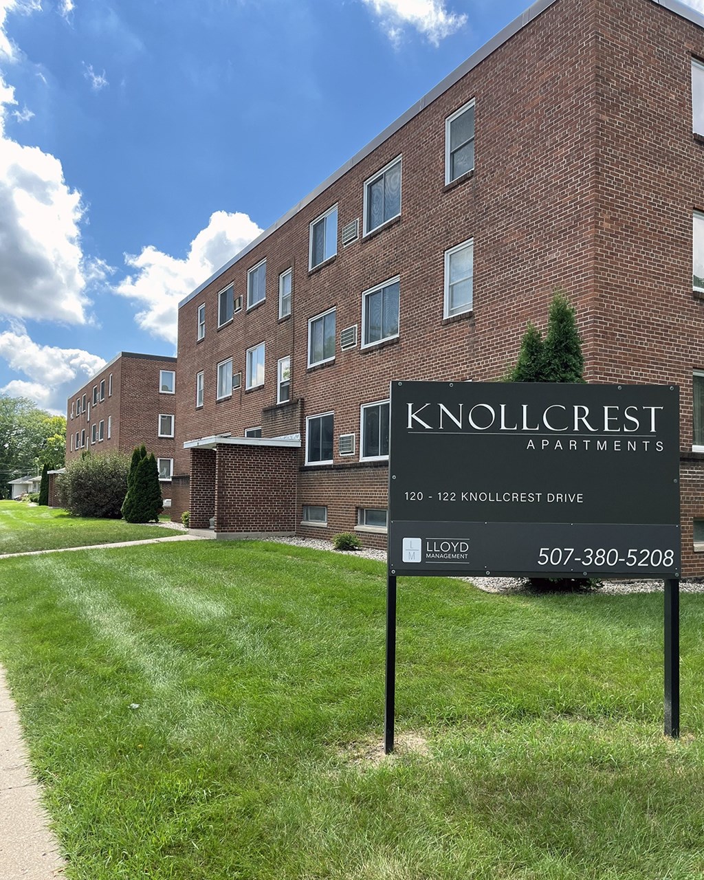 Knollcrest Apartments is a brick building with a sign in front.