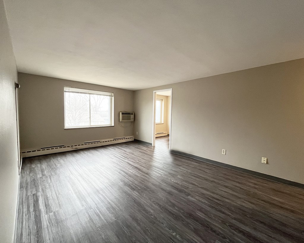A room with wooden floors and a window.