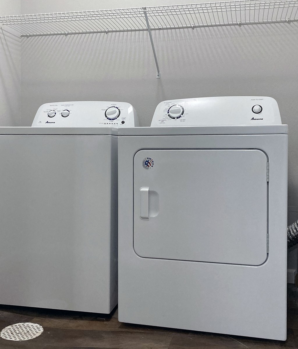 the washer and dryer are side by side in the laundry room