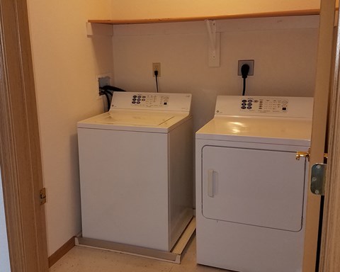 a laundry room with two washes and a dryer