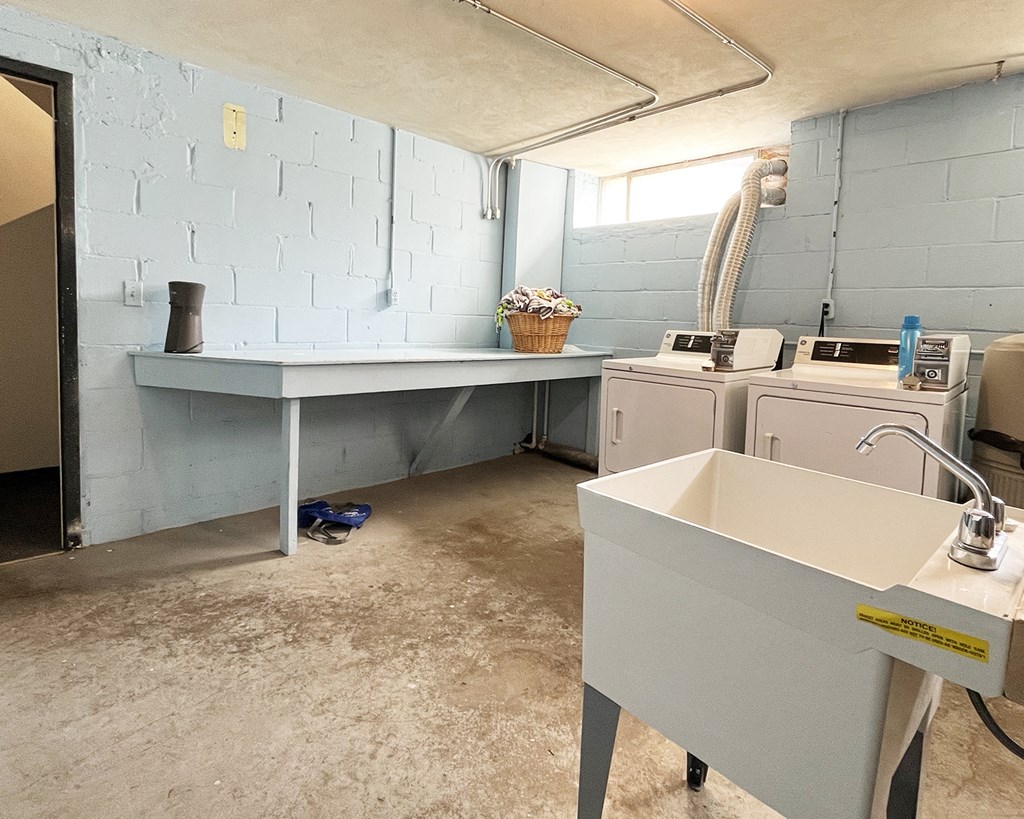 a laundry room with a sink and a washer and dryer in it