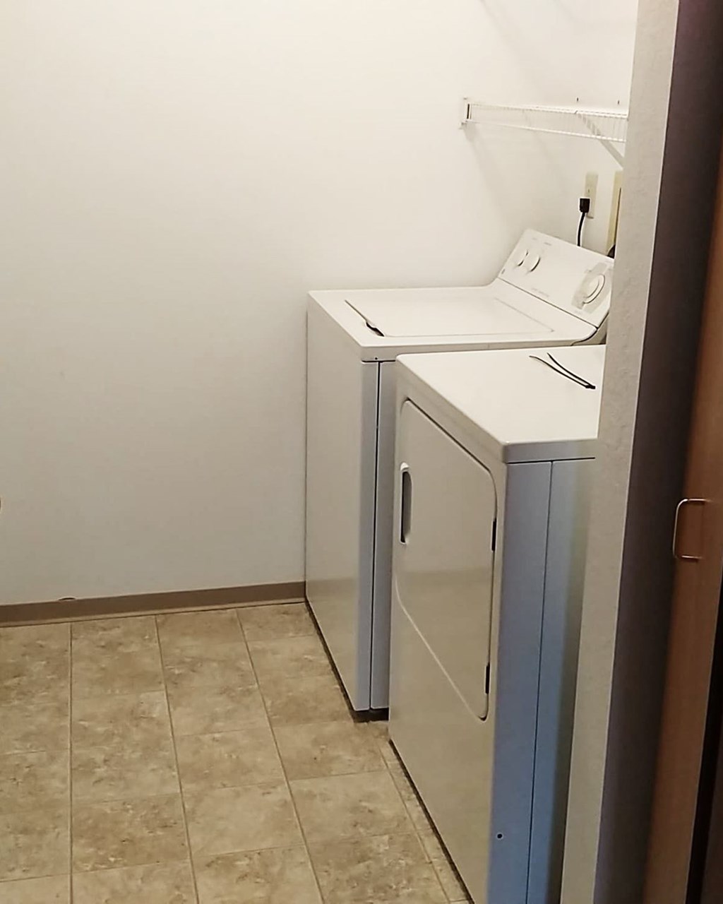 A white sink is in a small bathroom.