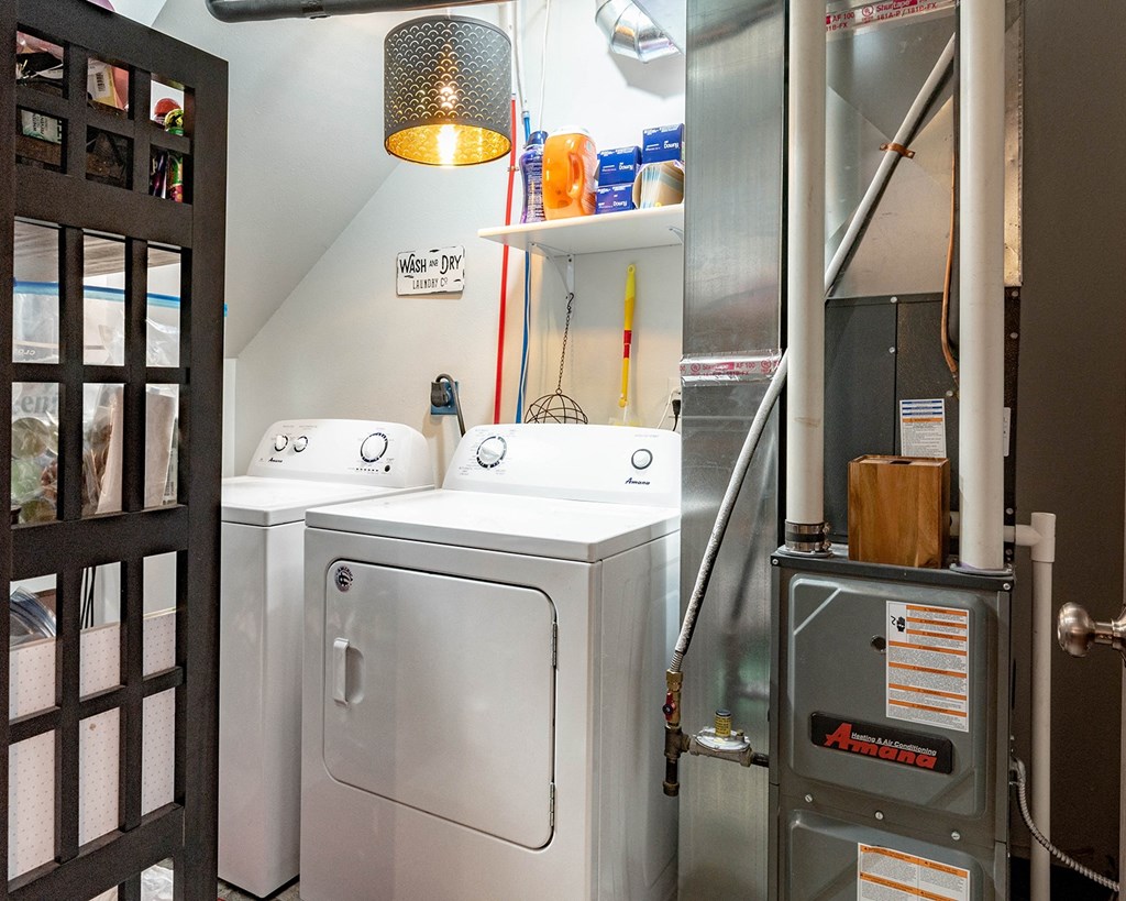 a small laundry room with two washes and a dryer