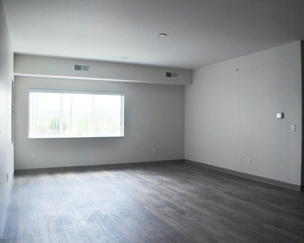 an empty bedroom with a large window