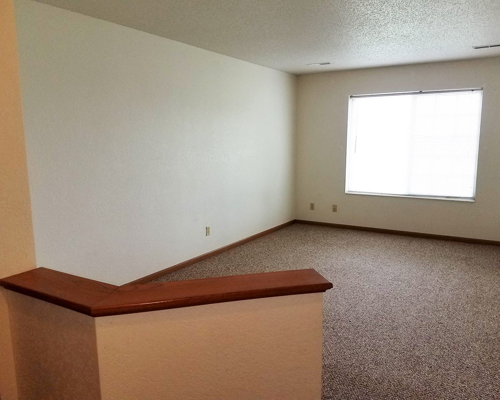 a living room with a couch and a window