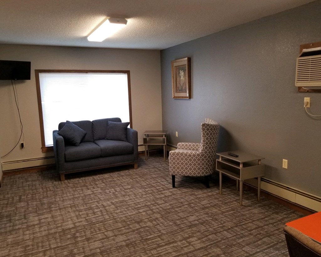 a living room with a couch and two chairs