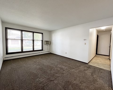 an empty living room with a large window