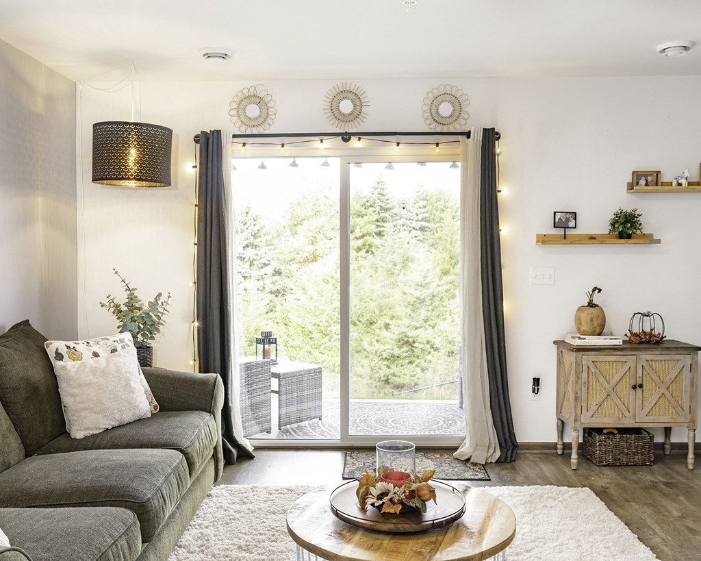 a living room with a couch and a sliding glass door