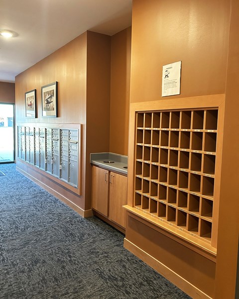 a small room with a book shelf and a sink in it