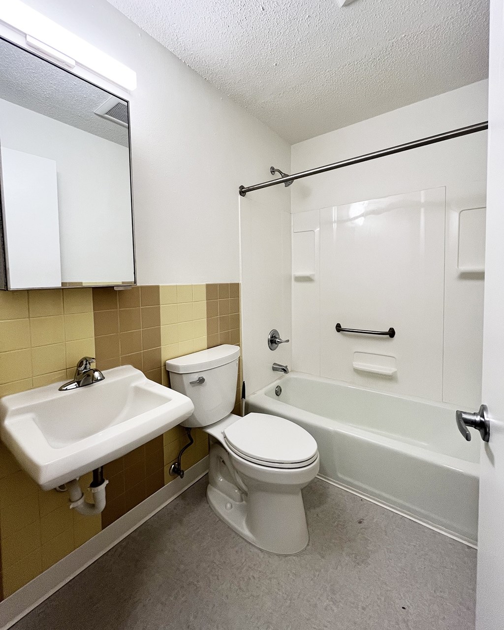 A white toilet and sink in a bathroom.