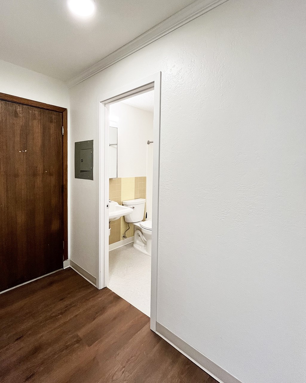 A white bathroom with a toilet and sink.