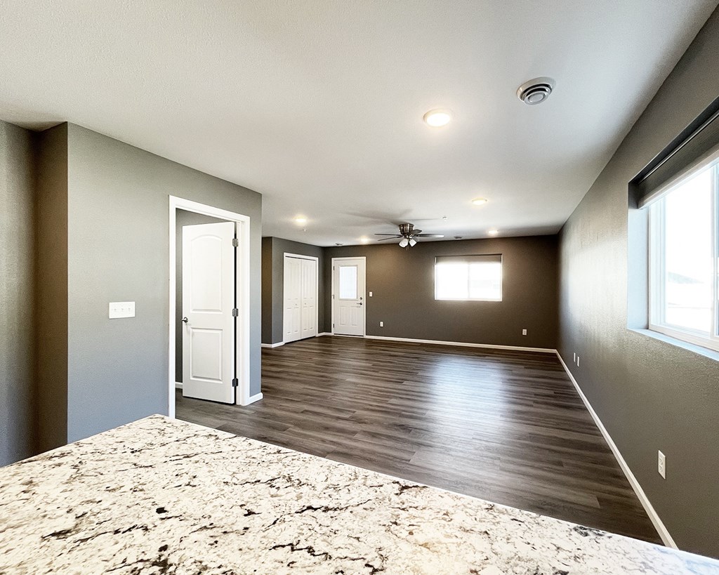 A large, empty room with a bed in the foreground.