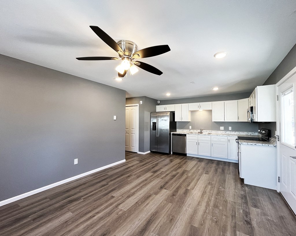 A kitchen with a refrigerator, stove, and oven.