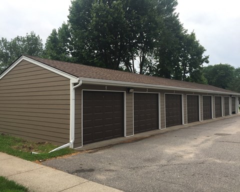 A long building with a brown siding and a brown roof.