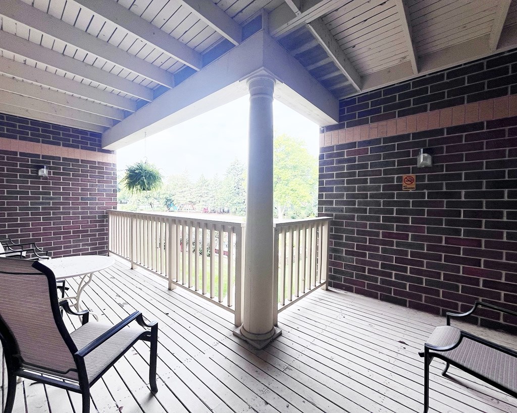 A balcony with a table and chairs.