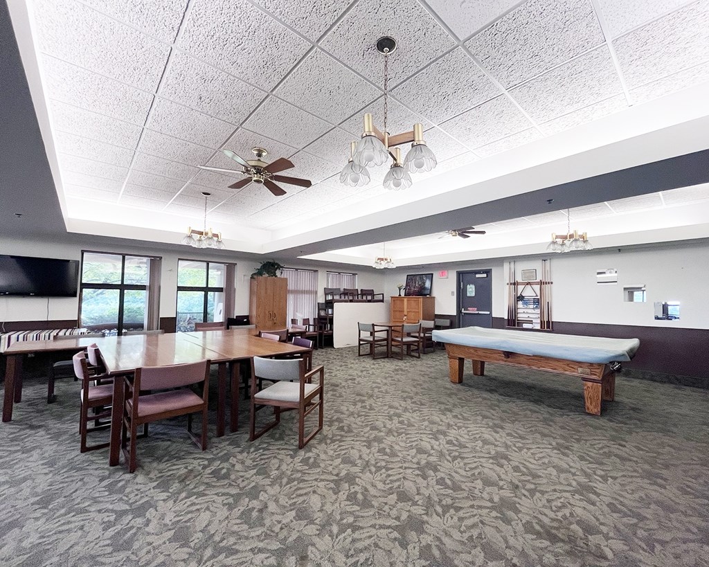 A room with a table and chairs and a bench.