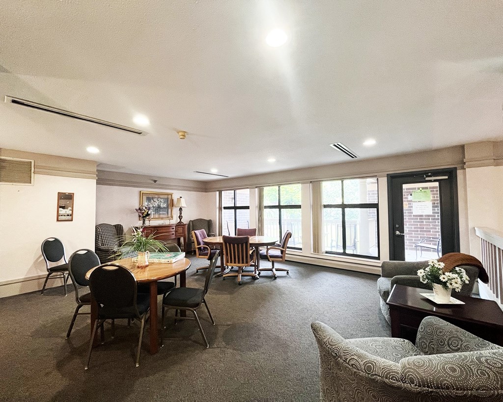 A dining room with a table and chairs.