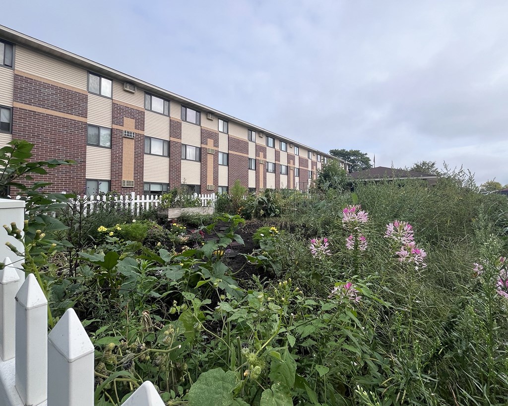 A building with a white picket fence in front of it.