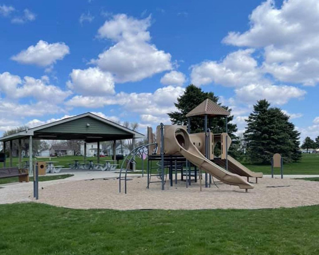 a playground with a slide and a pavilion