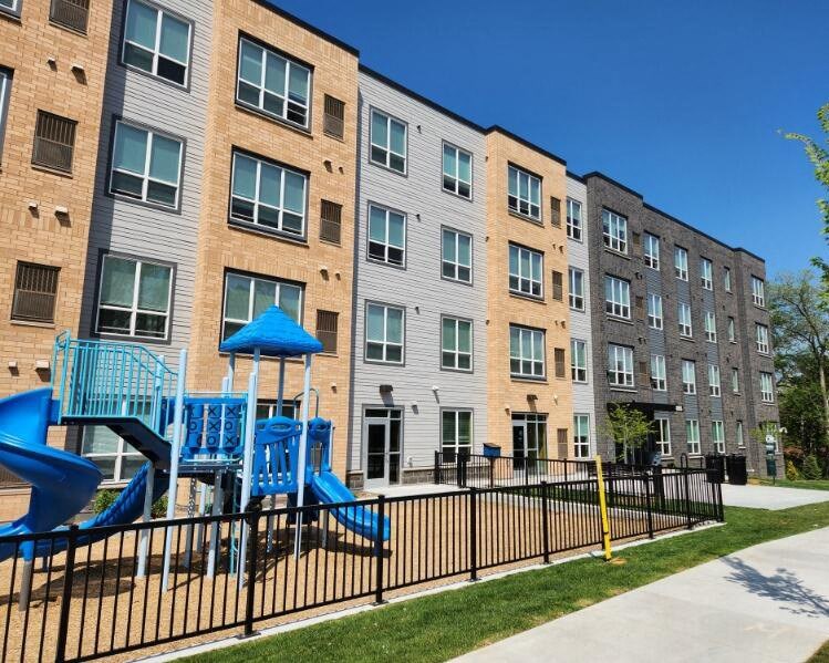 a playground in front of an apartment building