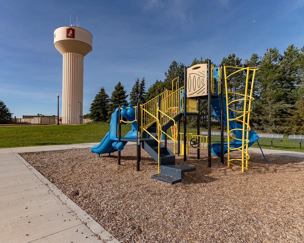 a playground with a water tower in the background