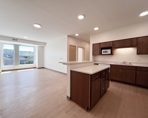 A kitchen with brown cabinets and a white countertop.
