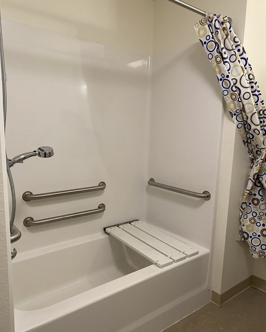 a bathroom with a shower and a toilet and a shower curtain