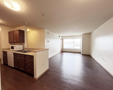 A kitchen with brown cabinets and white appliances.