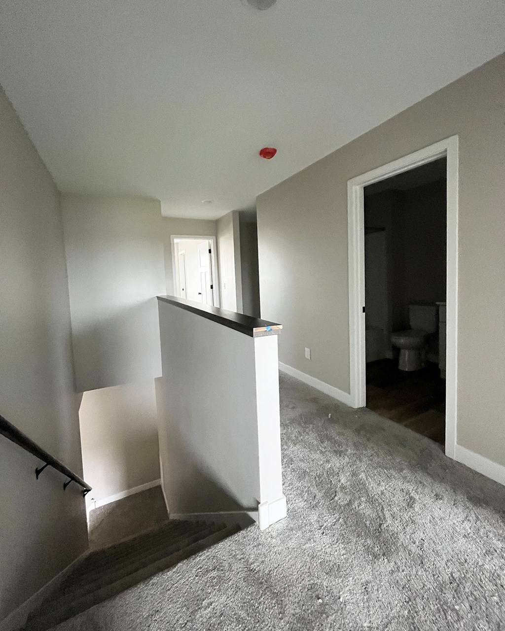 a view of the hallway from the top of the stairs