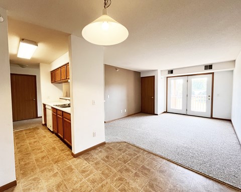 A kitchen area with a counter and cabinets is visible.