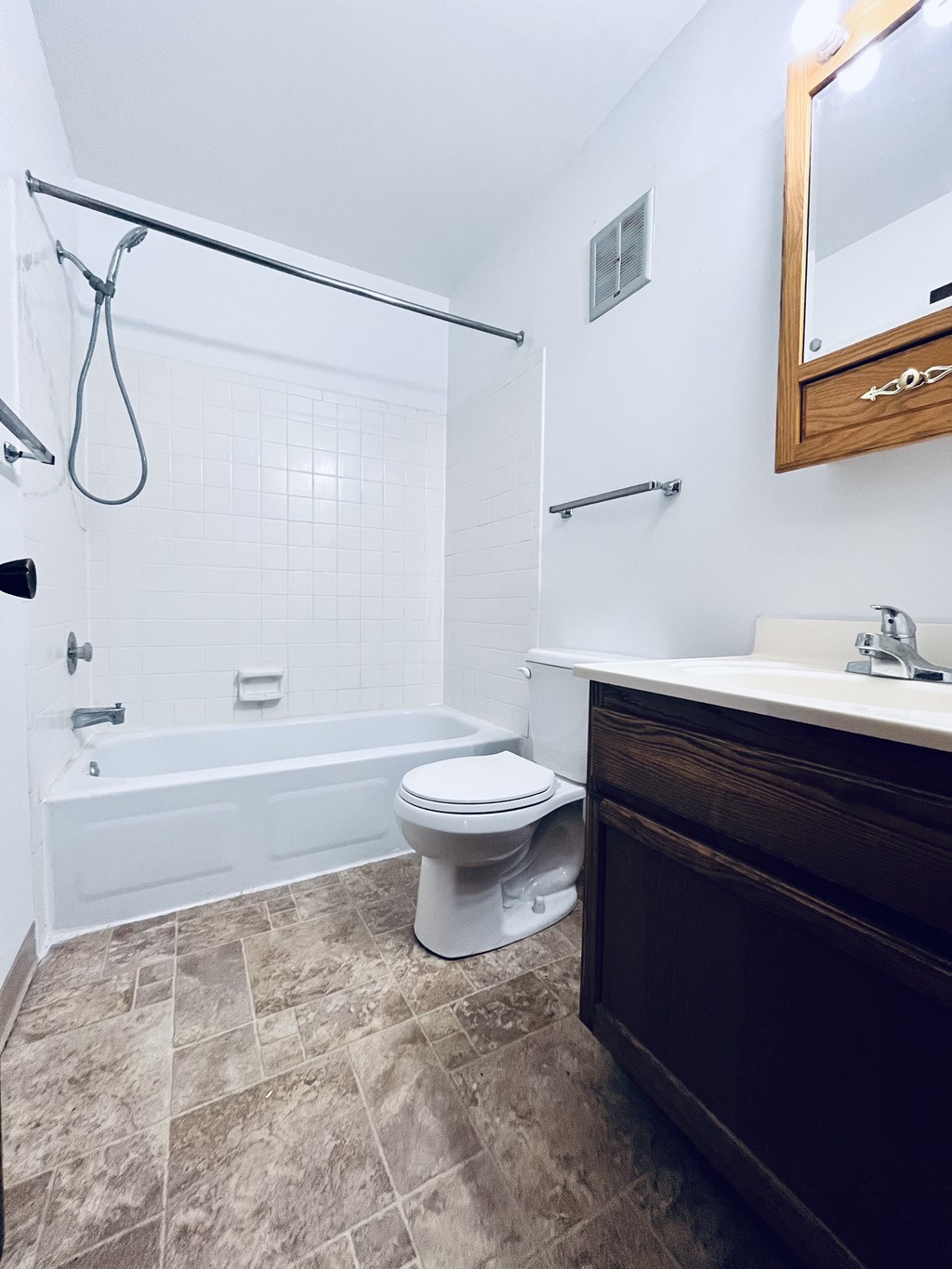 A bathroom with a toilet, sink, and bathtub.