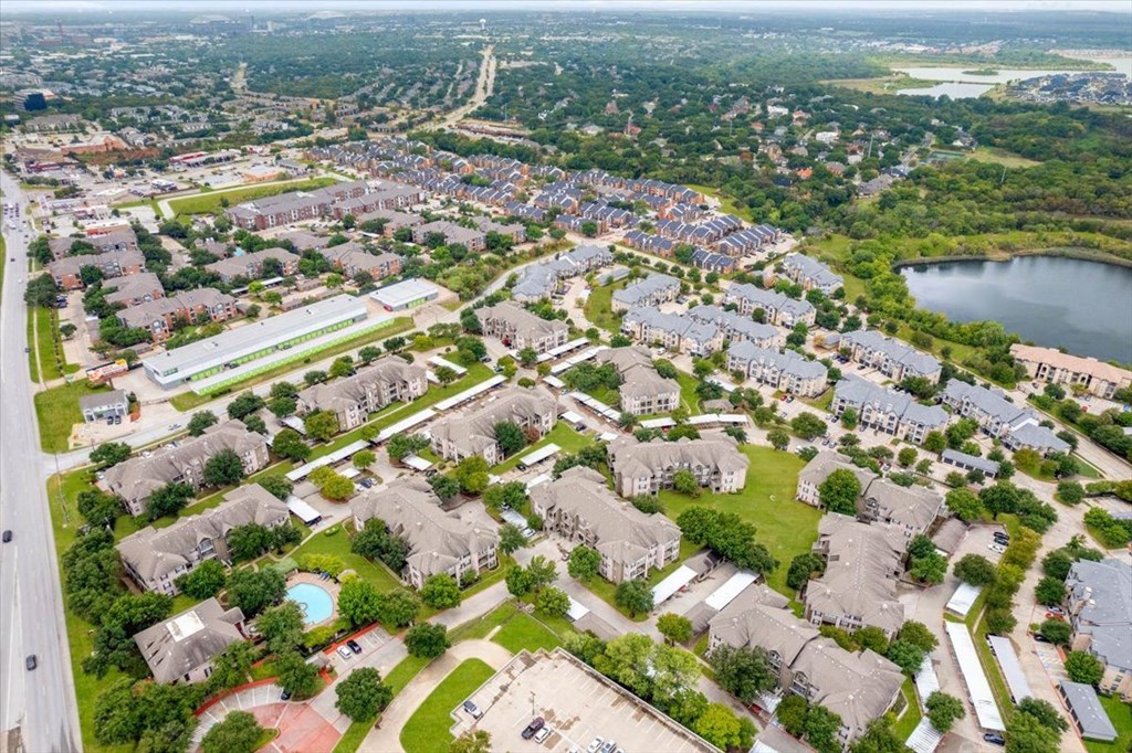 an aerial view of a neighborhood with houses and a lake at The Clairborne Apartment Homes, Grand Prairie, TX, 75050
