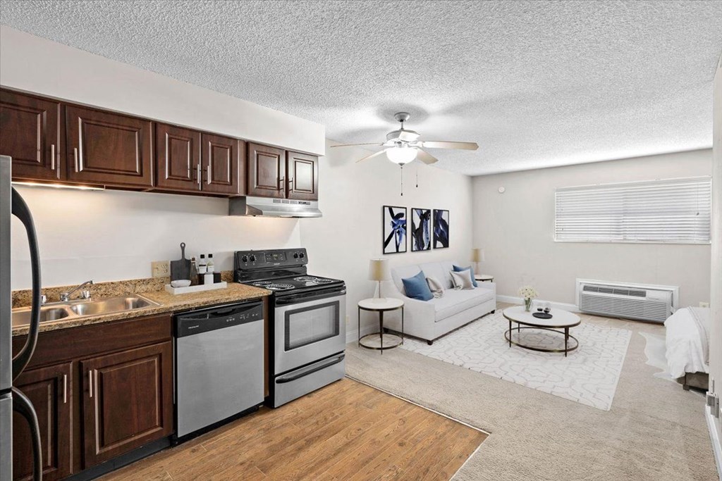 a kitchen and living room with a ceiling fan at Malvern Hill Apartment Homes, 66103, Kansas