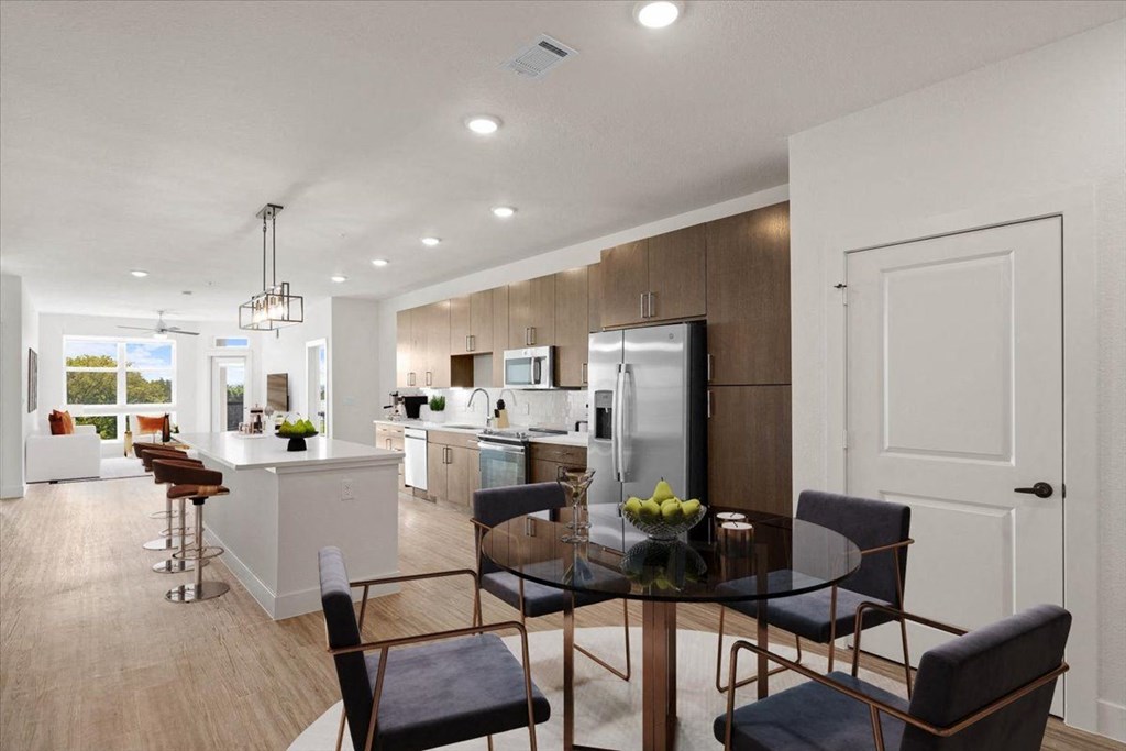 an open kitchen and dining room with a table and chairs