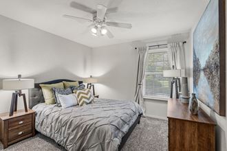 a bedroom with a bed and a ceiling fan at Pebblebrook, Overland Park, Kansas