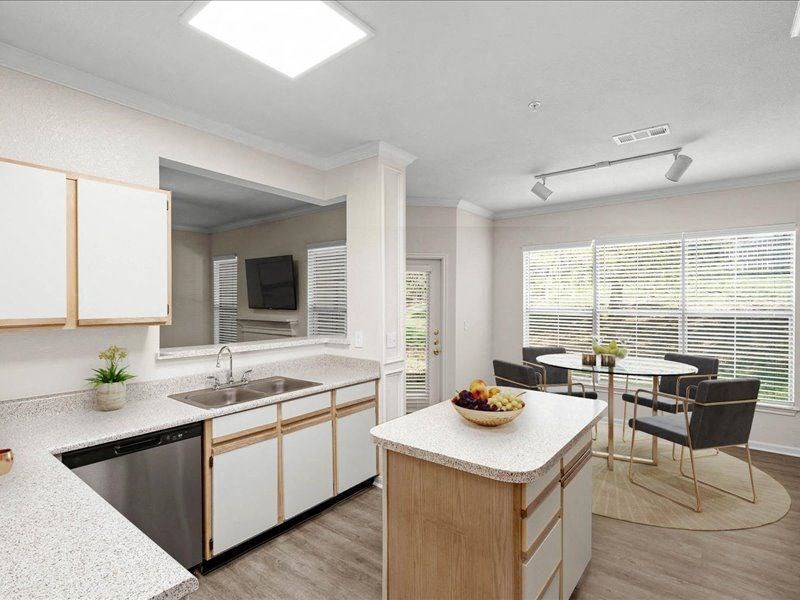 a kitchen with a sink and a table with chairs