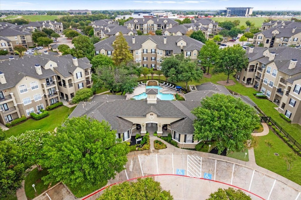 an aerial view of a large house with a swimming pool in the middle of it