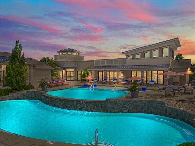 a large swimming pool with a building in the background