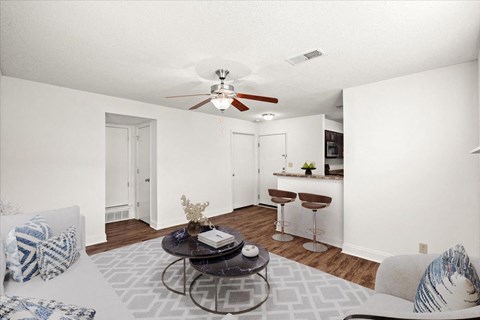 an open living room and kitchen with a ceiling fan at Fiesta Square Apartments & Townhomes, Overland Park