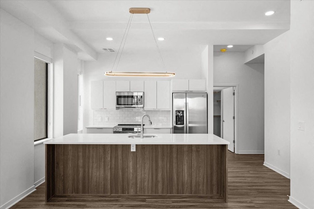 a kitchen with a counter top and a refrigerator at Sky On Main Apartments, Missouri