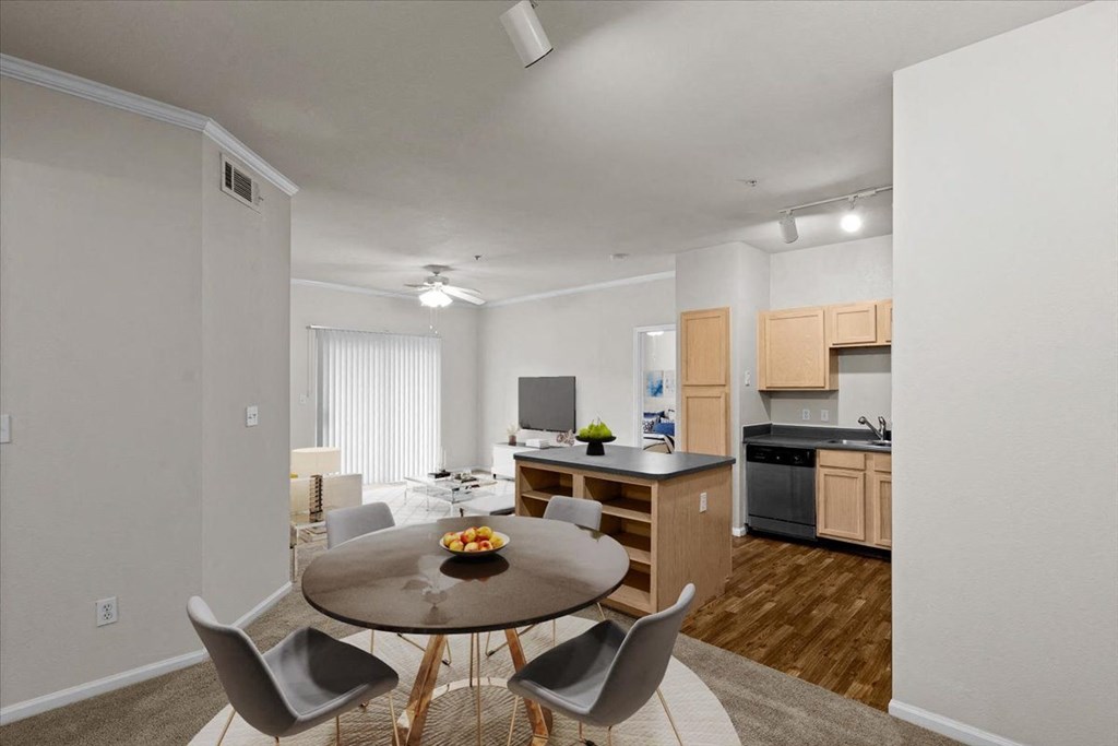a dining room and kitchen with a table and chairs